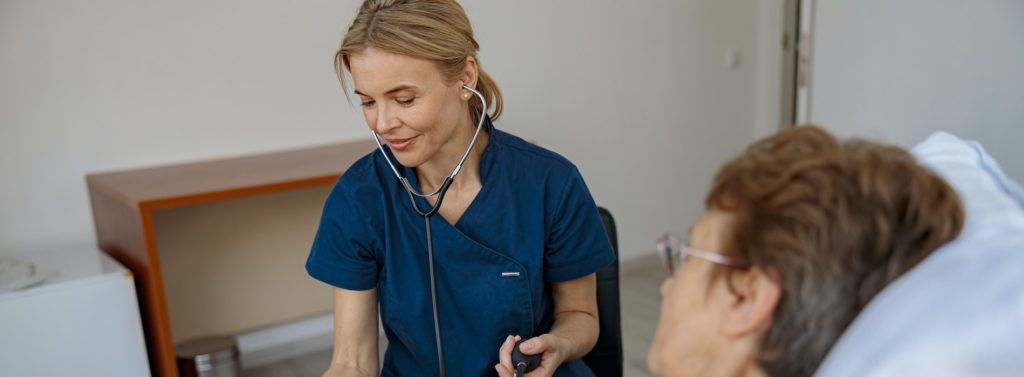female nurse checking blood pressure