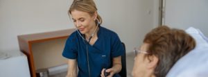 female nurse checking blood pressure