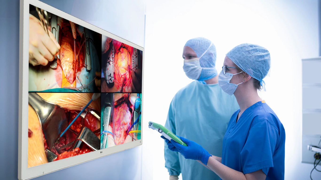 Surgeons viewing high-resolution medical images on LG surgical monitor during operation.