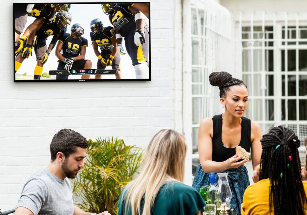 outdoor hotel tv Peerless AV outdoor wall mount supporting TV at restaurant patio