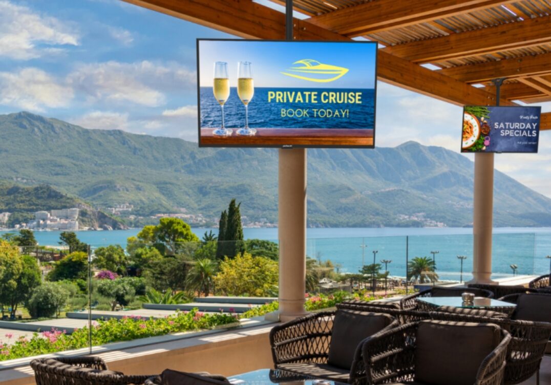 hotel digital signage Peerless AV outdoor wall mount supporting TV at restaurant patio