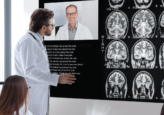 Medical professional reviewing patient records on LG diagnostic monitor for comprehensive care.