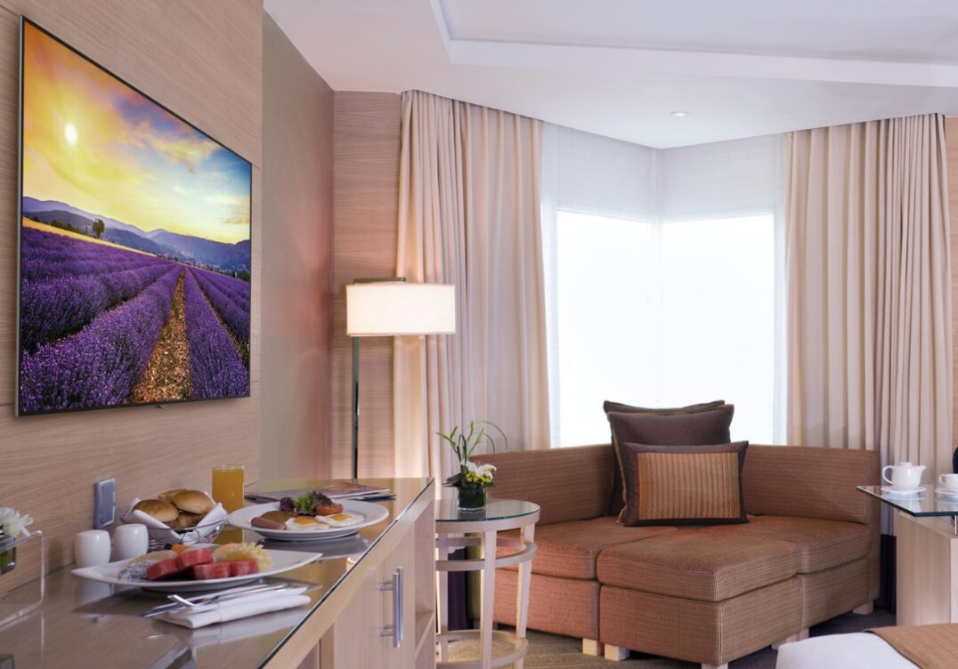 Peerless wall mount TV bracket installed in modern hotel guest room Peerless wall mount TV bracket installed in modern hotel guest room