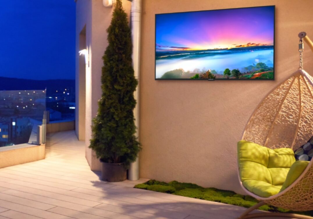 outdoor hotel tvs Peerless AV mount with sealed display at hotel courtyard lounge