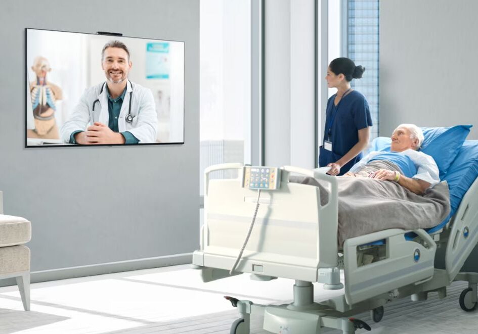 IPTV hospital Hospital patient speaking with a doctor via a TV-based telehealth session, delivered through an IPTV network in a patient room.