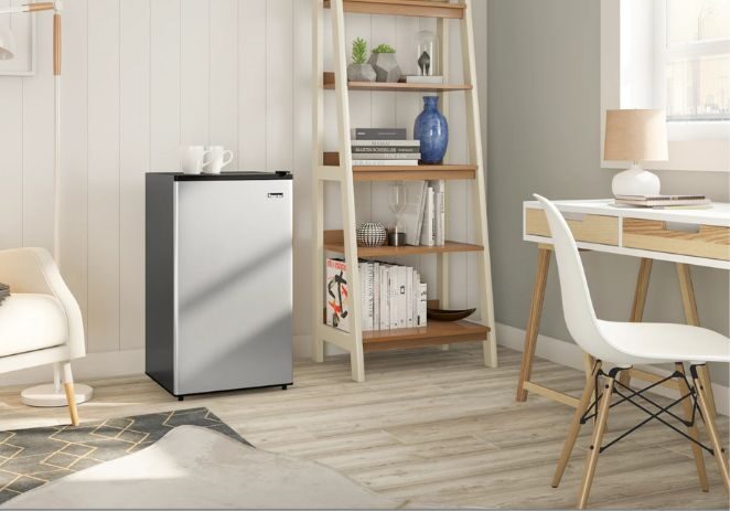 hotel mini fridge Modern hotel room with a compact mini fridge tucked beneath the counter, offering guests easy access to cold beverages and snacks.